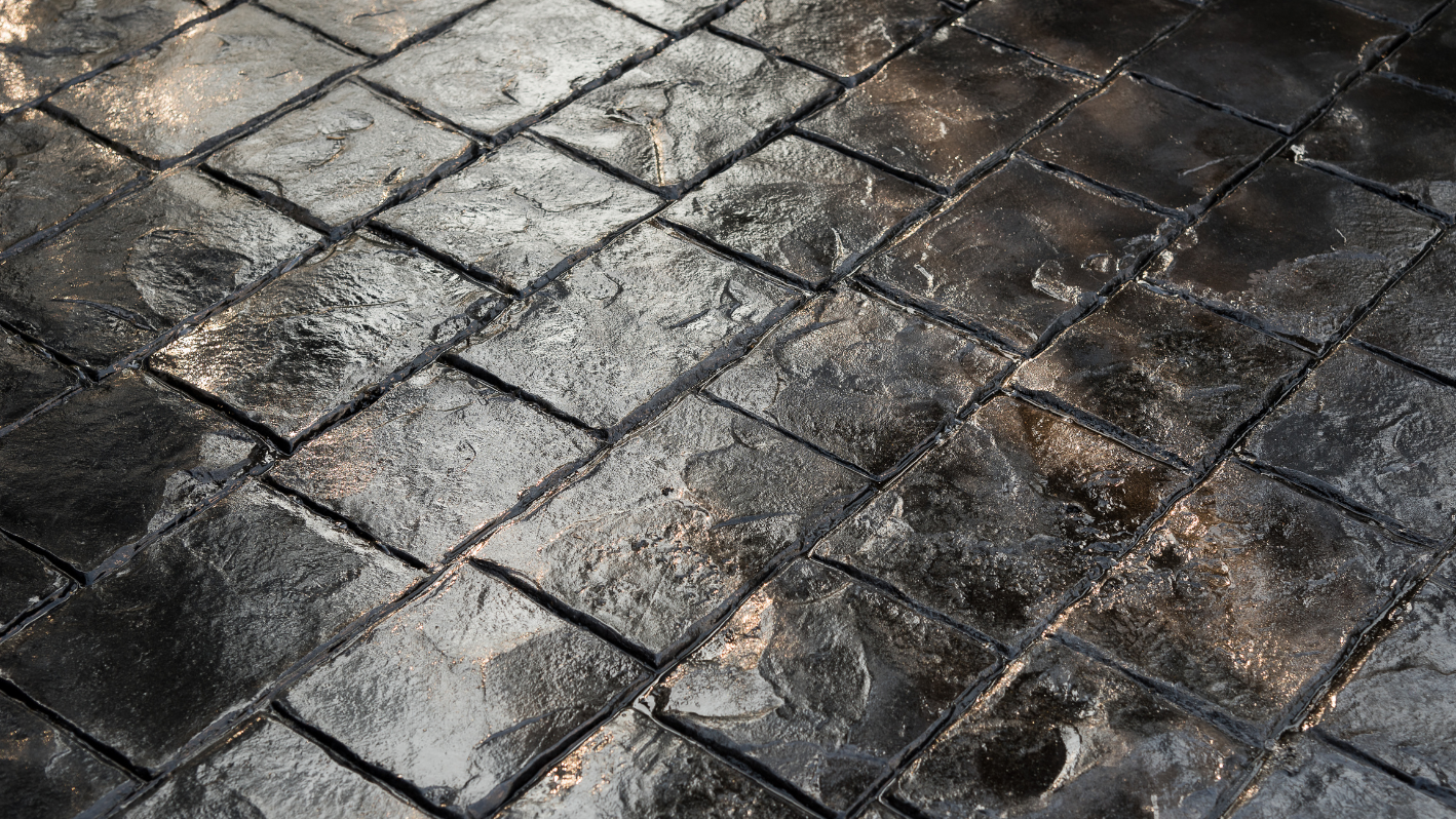 A close up of a tiled floor with water on it